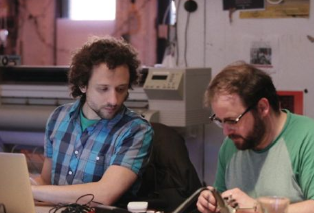 Picture of two guys making things.