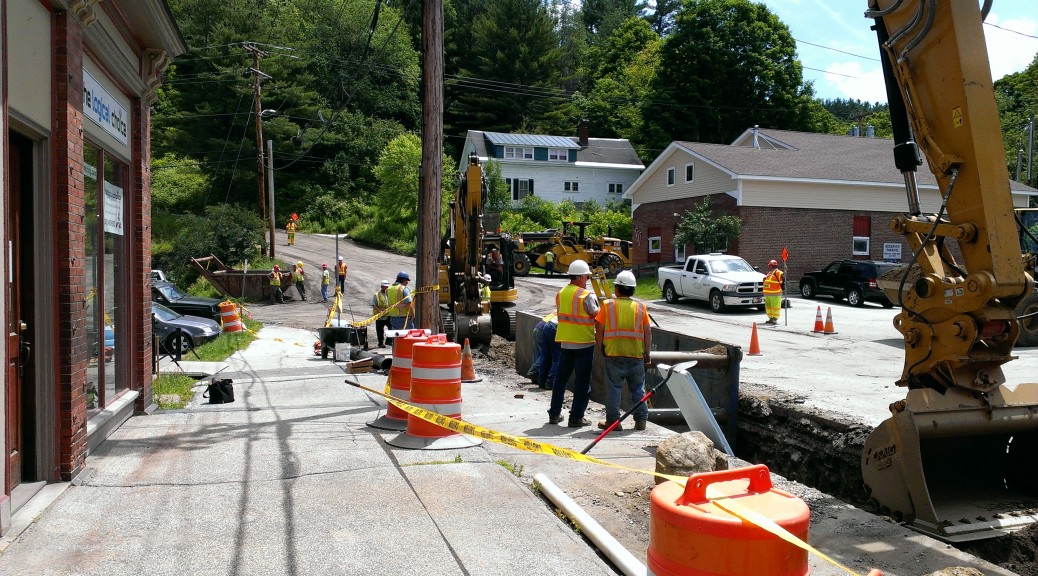 Picture of a trench being dug heading up the street.